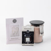 The Sweet Grace Starter Bundle includes a candle, scented sachet, and auto vent clip in elegant white packaging with angel wing designs.