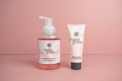 The Sweet Grace Foam & Pamper Bundle, featuring foaming hand soap and hand cream, is displayed side by side on a pink surface with a matching pink background.